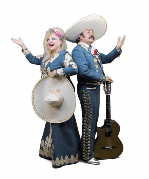 Picture of the duo Die Carinos in original Mexican mariachi costumes with real sombreros. These two, Marion from Bavaria and Eddy, an original mariachi from Mexico, have managed to create a perfect symbiosis of the German Schlager and the Mexican mariachi sound. Mariachi is now a world cultural heritage. The Carinos entertain you every Wednesday and Saturday at Cafe Marlene.